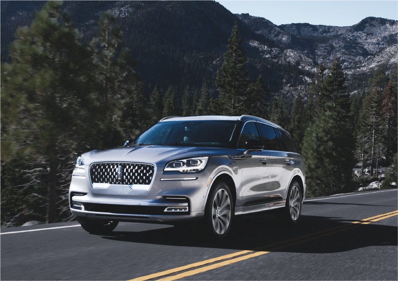 A 2023 Lincoln Aviator® Grand Touring SUV being driven on a winding road to demonstrate the capabilities of all-wheel drive | Dave Sinclair Lincoln in Ballwin MO