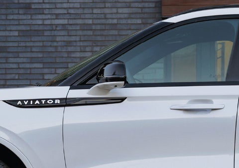 The driver’s side door and fender badging of a white 2026 Lincoln Aviator® SUV are showcased. | Dave Sinclair Lincoln in Ballwin MO