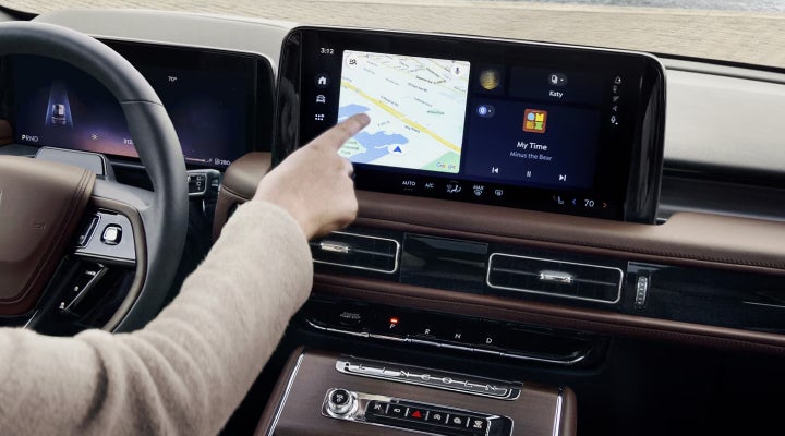 A person is tapping the center display touchscreen of a 2026 Lincoln Aviator® SUV. | Dave Sinclair Lincoln in Ballwin MO