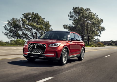 A 2026 Lincoln Corsair® SUV is shown being driven on a country road. | Dave Sinclair Lincoln in Ballwin MO