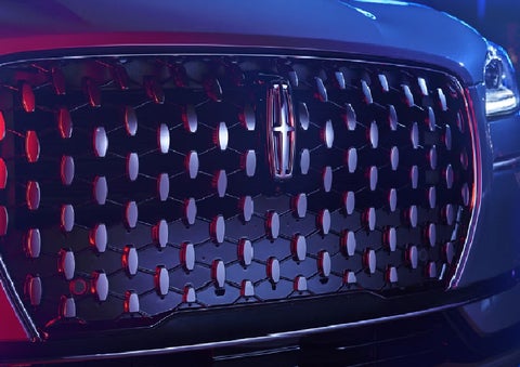 The grille of a 2025 Lincoln Corsair&reg; SUV reflects neon light at night. | Dave Sinclair Lincoln in Ballwin MO