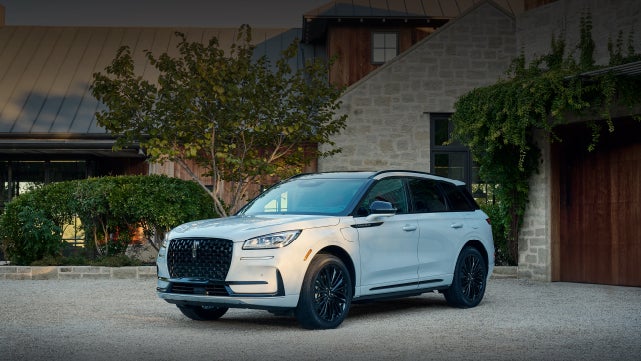 A 2026 Lincoln Corsair® SUV is parked in front off a luxury home. | Dave Sinclair Lincoln in Ballwin MO