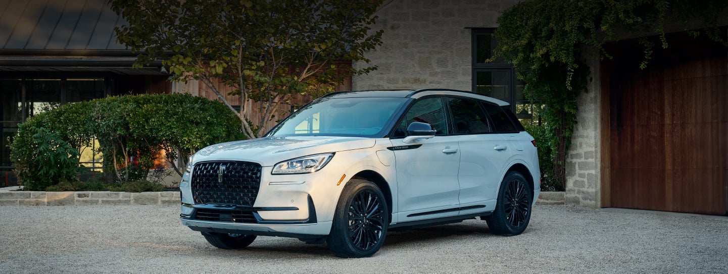 A 2026 Lincoln Corsair® SUV is parked in front off a luxury home. | Dave Sinclair Lincoln in Ballwin MO