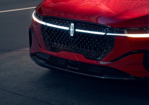 The available front LED light bar and center Lincoln Star logo glow at dusk. | Dave Sinclair Lincoln in Ballwin MO