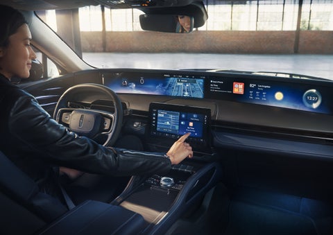 The driver of a 2026 Lincoln Nautilus® SUV interacts with the center touchscreen. | Dave Sinclair Lincoln in Ballwin MO
