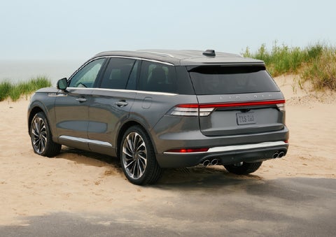 A 2027 Lincoln Aviator® SUV is parked next to sand dunes. | Dave Sinclair Lincoln in Ballwin MO