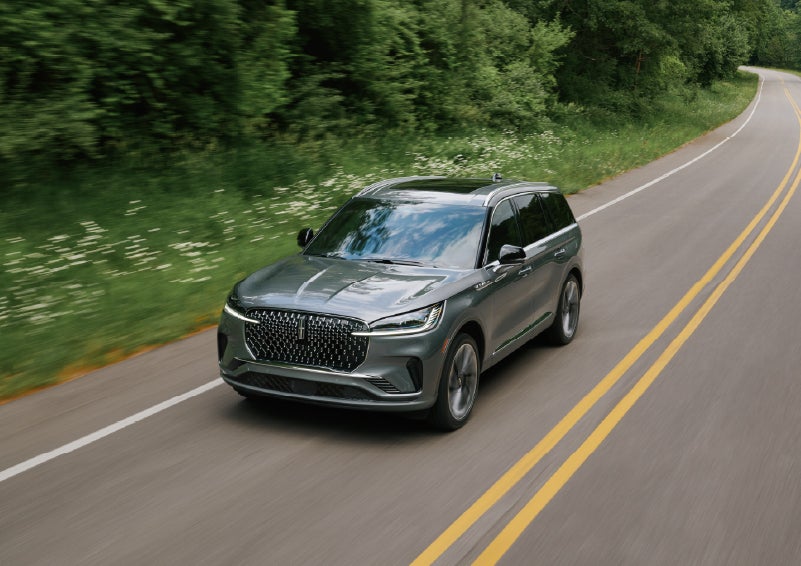 A 2027 Lincoln Aviator® SUV is being driven down a road. | Dave Sinclair Lincoln in Ballwin MO