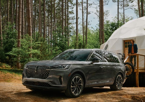 A 2027 Lincoln Aviator® is parked next to a high end glamping site. | Dave Sinclair Lincoln in Ballwin MO