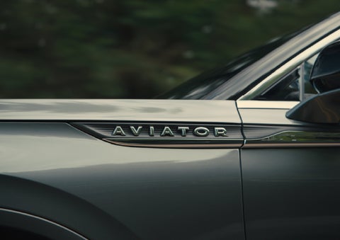The driver’s side door and fender badging of a gray 2027 Lincoln Aviator® SUV are showcased. | Dave Sinclair Lincoln in Ballwin MO