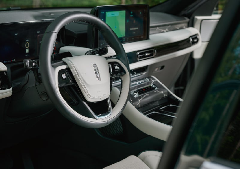 The leather-trimmed steering wheel of a 2027 Lincoln Aviator® Black Label™ SUV. | Dave Sinclair Lincoln in Ballwin MO