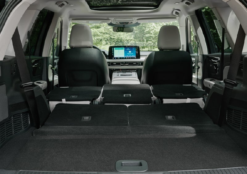 A rear to front view of the interior of a 2027 Lincoln Aviator® Black Label™ SUV shows the third and second rows folded flat | Dave Sinclair Lincoln in Ballwin MO