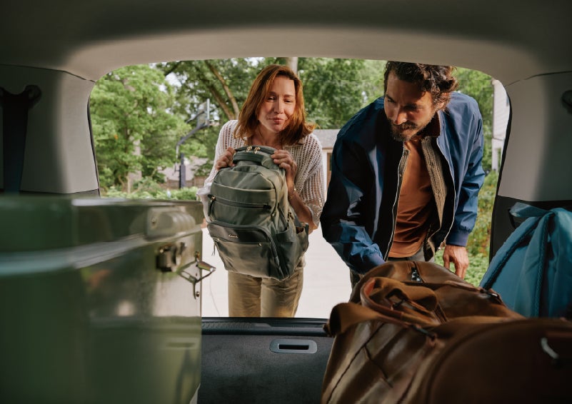 A couple loads luggage into the rear of a 2027 Lincoln Aviator® Black Label™ SUV..e 202 | Dave Sinclair Lincoln in Ballwin MO