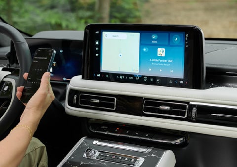 A person pairs thier phone with the center touchscreen of a 2027 Lincoln Aviator® Black Label™ SUV | Dave Sinclair Lincoln in Ballwin MO